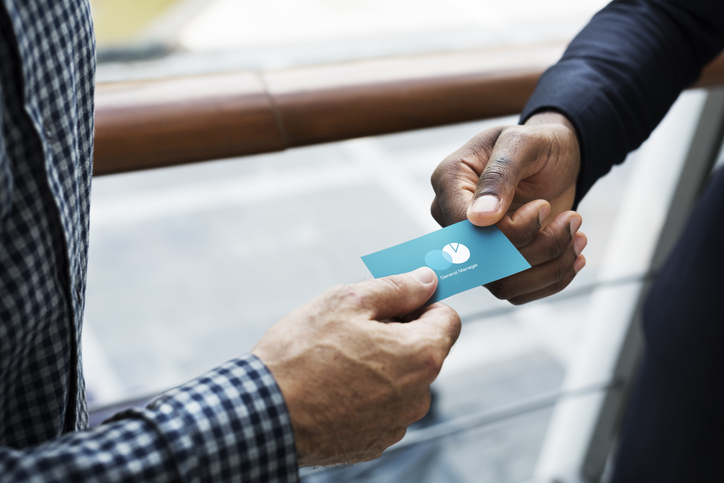 Business people exchanging a business card Custom Business Cards That People Actually Keep