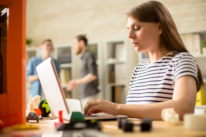 Young Woman Operating 3D Printer How to save money on printing at SBS without cutting corners as a student